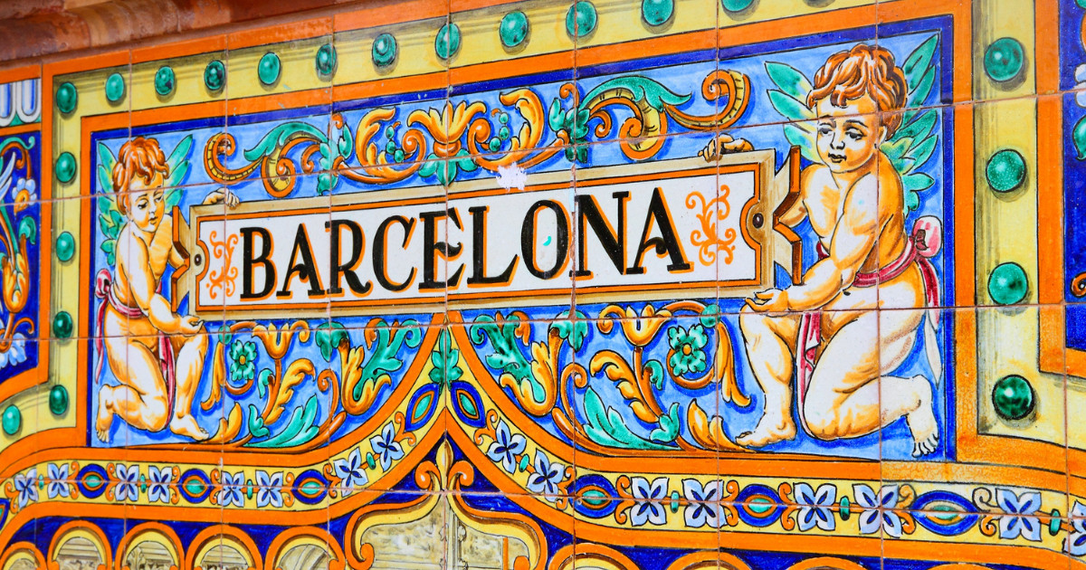 Barcelona Sign. Made out of colourful tiles, the word Barcelona sits between two ancient angel like figures.
