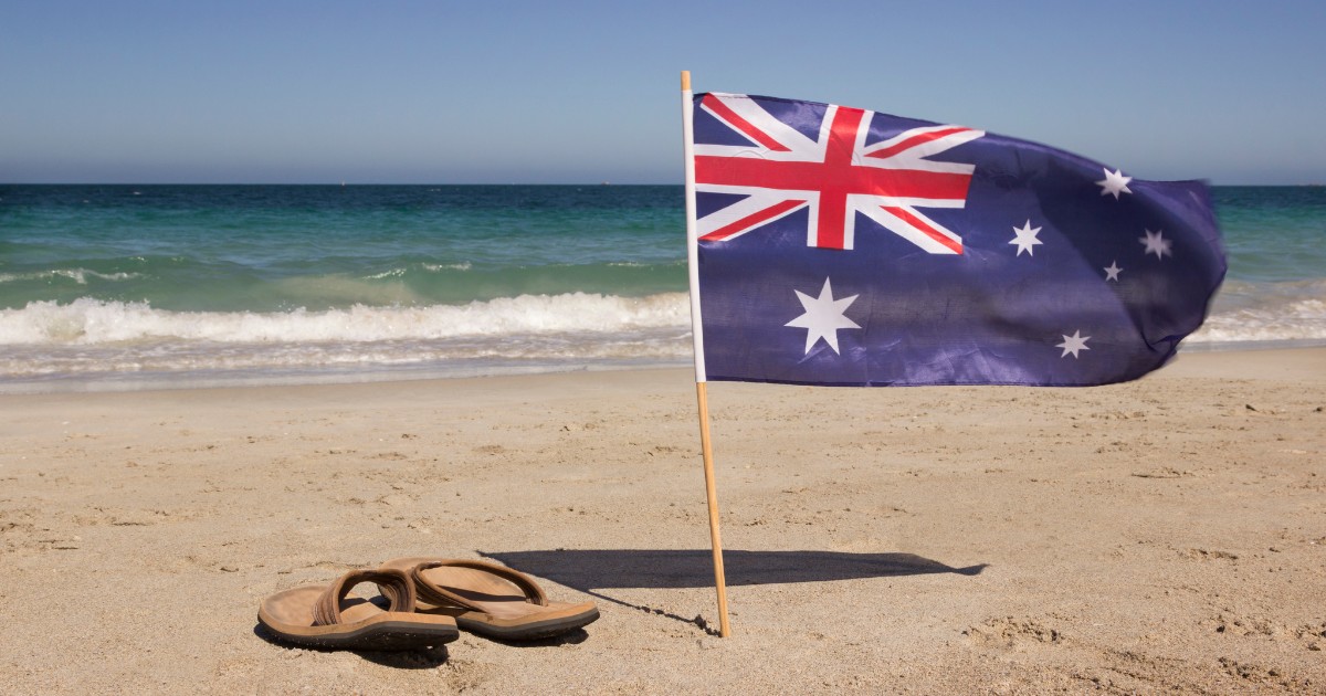 Australian beach with flip flops and Australia's flag