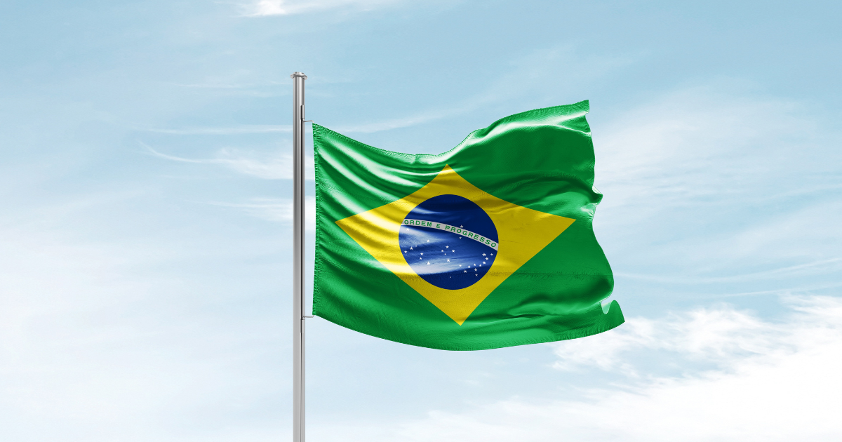 Brazil national flag waving in beautiful sky.