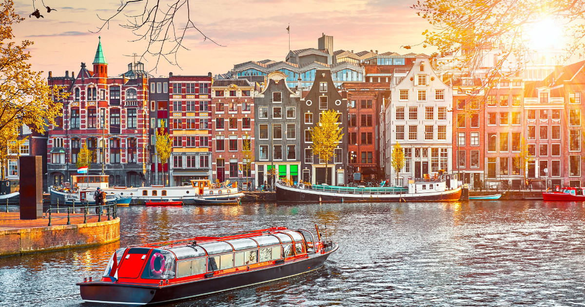 Channel in Amsterdam Netherlands houses river Amstel landmark old european city spring landscape