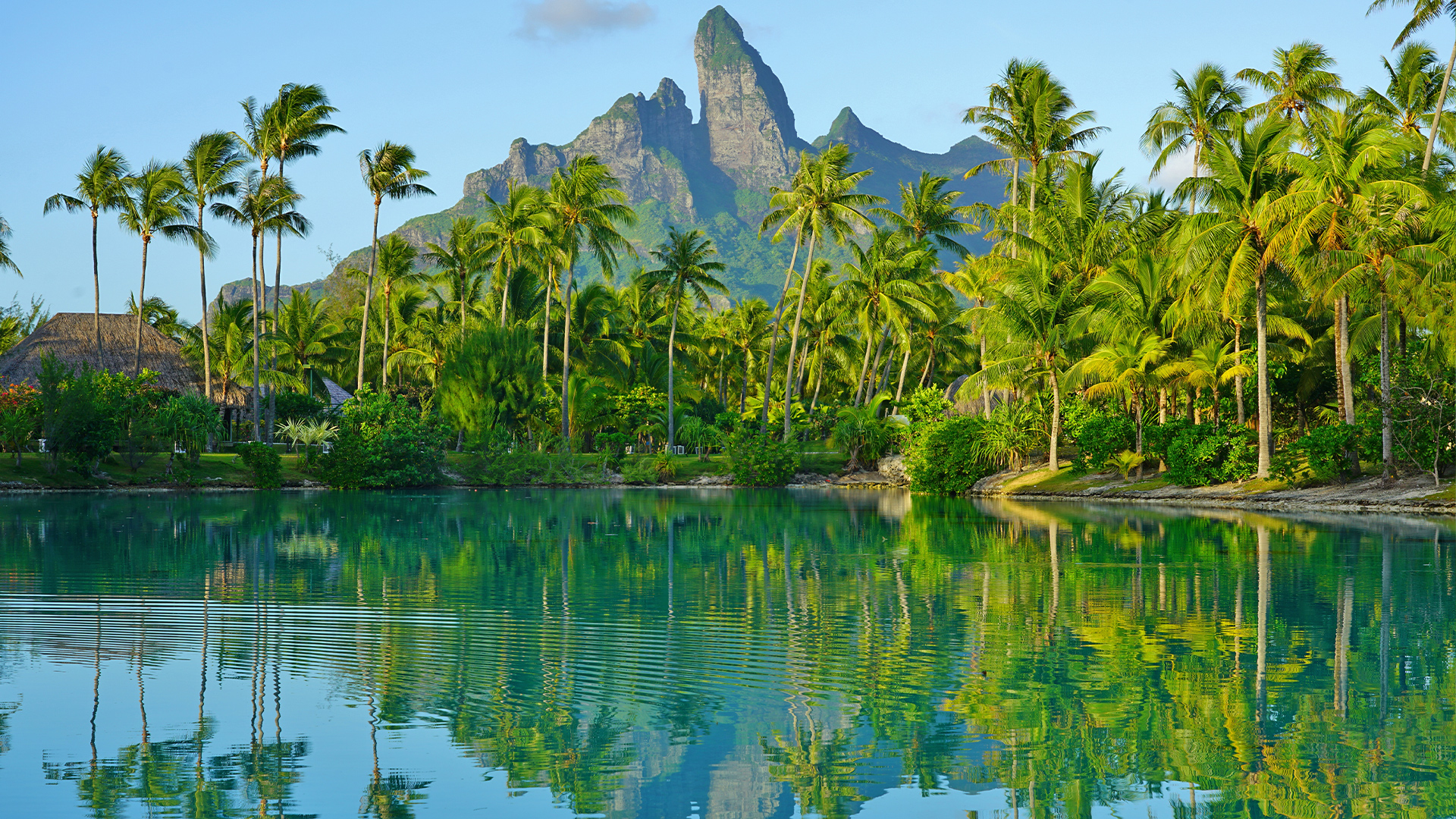 Destinations: View of the Mont Otemanu Reflecting in the Water at Sunset on Bora Bora, French Polynesia, Oceania