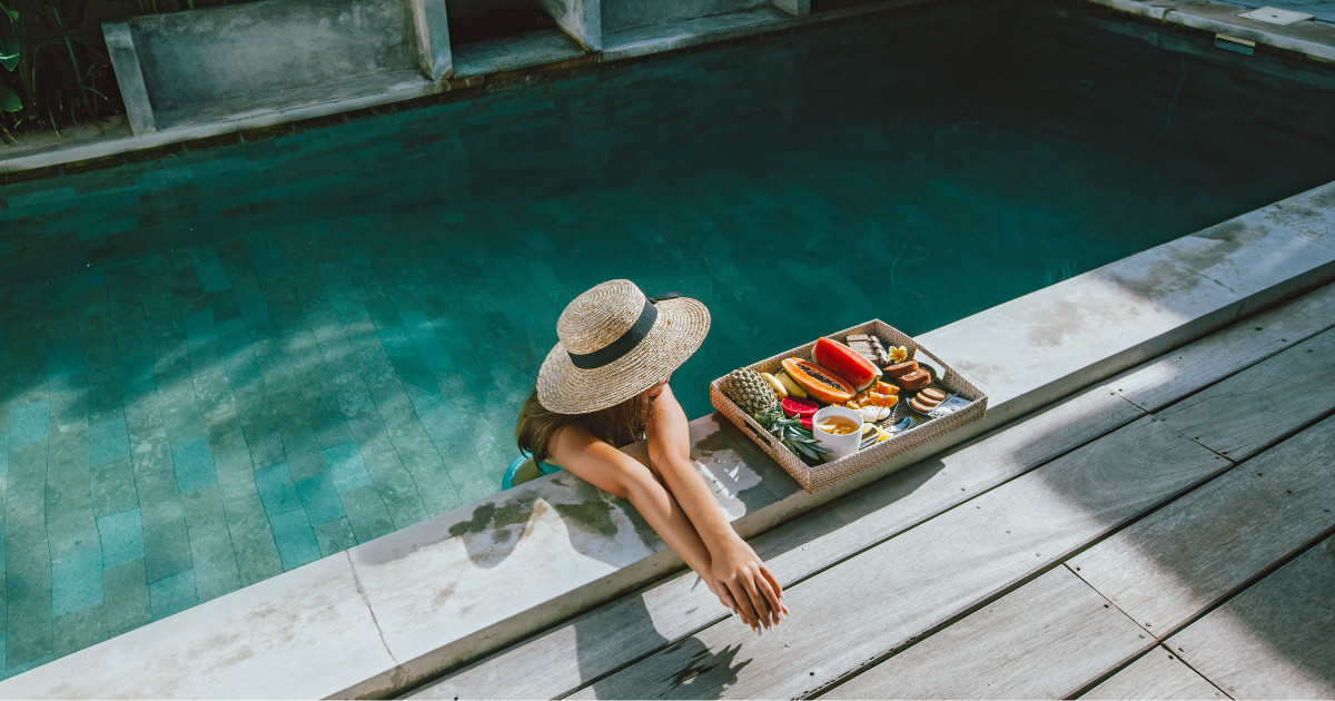 Woman eating fruit in pool
